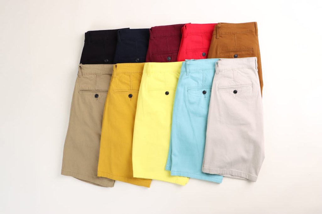 Flat lay of colorful men's shorts in different styles and colors, ideal for summer fashion.